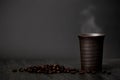 Classic still life - a cup of coffee with smoke and roasted coffee Royalty Free Stock Photo