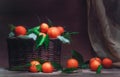 Classic Still life with mandarins with leaves in basket and drapery