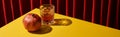 Classic still life with pomegranate near glass of red wine on yellow table near red curtain, panoramic shot Royalty Free Stock Photo