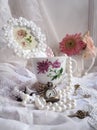 Classic stilllife with pearl, berbeda, cup and vintage clock Royalty Free Stock Photo