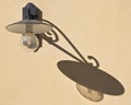 Classic streetlight against a plaster wall with shadow Royalty Free Stock Photo