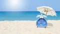 Classic style blue alarm clock with plumeria flower and white beach umbrella with space on blurred tropical beach background