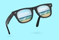 Classic sunglasses with reflection of sea isolated on blue background Royalty Free Stock Photo