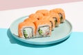 Classic sushi roll with salmon outside, crab, cheese and cucumber inside. Philadelphia maki in minimal style. Modern japanese menu