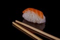 classic sushi with salmon over black background