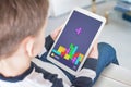 Classic tetris game on tablet in boy hand