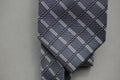 Classic tie fabric texture close-up with a business style pattern on a gray background Royalty Free Stock Photo