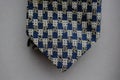 Classic tie fabric texture close-up with a business style pattern on a gray background Royalty Free Stock Photo