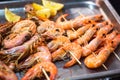 Classic tiger shrimp skewers. Shrimps sriracha kebabs with lemon for dinner. Delicious prawn spit prepared on grill. Extreme close Royalty Free Stock Photo