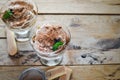 Classic tiramisu cake in a glass with fresh mint, on wooden background