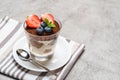 Classic tiramisu dessert with blueberries and strawberries in a glass on concrete background Royalty Free Stock Photo