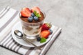 Classic tiramisu dessert with blueberries and strawberries in a glass on concrete background Royalty Free Stock Photo