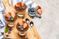 Classic tiramisu dessert with blueberries and strawberries in a glass on concrete background Royalty Free Stock Photo