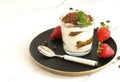 Classic tiramisu, traditional Italian dessert in a glass on a marble table,