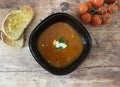 Tomato cream soup with burrata, basil and toasted ciabatta with olive oil.