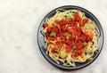 A classic traditional Italian dish, Tagliatelle alla Bolognese, flat egg pasta with a meat sauce on a round plate