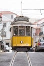 Classic traditional yellow trolley tram 28 on track in Lisbon