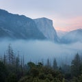 Classic Tunnel View of scenic Yosemite Valley with famous El Capitan and Half Dome rock climbing summits in beautiful atmosphere Royalty Free Stock Photo