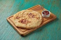 Classic Turkish bread flatbread served on a wooden board on a green background. Turkish bread Royalty Free Stock Photo