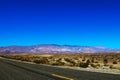 Classic vertical panorama view of an endless straight road running through the barren scenery of the American Southwest with Royalty Free Stock Photo