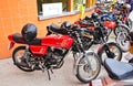 Classic Vespa, zundapp, Famel XF, Piaggio, and Sachs V5 motorcycles on display on a street