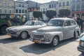 Vintage grey Swedish cars Volvo B16 and P1800 at a car show parked