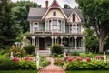 classic victorian house with front porch and welcoming, floral garden Royalty Free Stock Photo