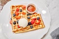 Classic Viennese waffles with ice cream, berries and Maple syrup. Breakfast in cafe. Table in the restaurant. Royalty Free Stock Photo