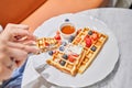 Classic Viennese waffles with ice cream, berries and Maple syrup. Breakfast in cafe. Table in the restaurant. Royalty Free Stock Photo