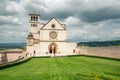 Classic view of famous Basilica of St. Francis of Assisi in beautiful spring day light with dramatic clouds in the sky