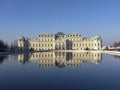 Classic view of famous Schonbrunn Palace with scenic Great Parterre garden on a beautiful sunny day with blue sky and clouds in Royalty Free Stock Photo