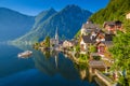 Classic view of Hallstatt with ship at sunrise, Salzkammergut, A Royalty Free Stock Photo