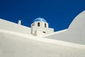 Classic view of white church with blue domes - Oia village, Santorini Island in Greece Royalty Free Stock Photo