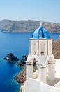 Classic view of white church with blue domes - Oia village, Santorini Island in Greece Royalty Free Stock Photo