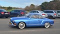 Classic vintage antique blue VW Karmann Ghia coupe driving Royalty Free Stock Photo