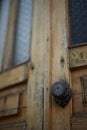 Classic black door knobs with carvings on old brown wooden doors Royalty Free Stock Photo