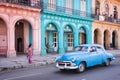 Classic vintage car and colorful colonial buildings in the main street of Old Havana