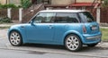 Old small blue car Mini Cooper parked left side view Royalty Free Stock Photo