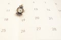 Classic vintage necklace watch on calendar paper