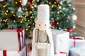 Classic vintage nutcracker on New Year background. Wooden toy nutcracker, classic decorations. Christmas mood in children room. So