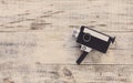 Classic vintage old 8mm movie camera on old wooden boards. Hipster style. Top view with copy space. Free space for text. Royalty Free Stock Photo