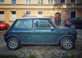 Old classic vintage car small green Morris Mini Cooper parked