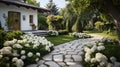 Classic and vintage pathway with green yard white rocks and flower bush