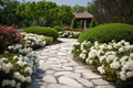 Classic and vintage pathway with green yard white rocks and flower bush