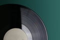 Classic vinyl record close-up on a green background, obsolete data storage, music Royalty Free Stock Photo