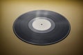 Classic vinyl record close-up on a yellow background, obsolete data storage, music