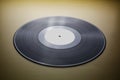 Classic vinyl record close-up on a yellow background, obsolete data storage, music Royalty Free Stock Photo
