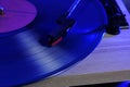 Classic vinyl record player closeup with contoured blue light. Royalty Free Stock Photo