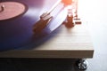 Classic vinyl record player closeup with contoured sunlight.