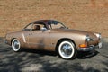 Volkswagen Karman Ghia with brick wall in background